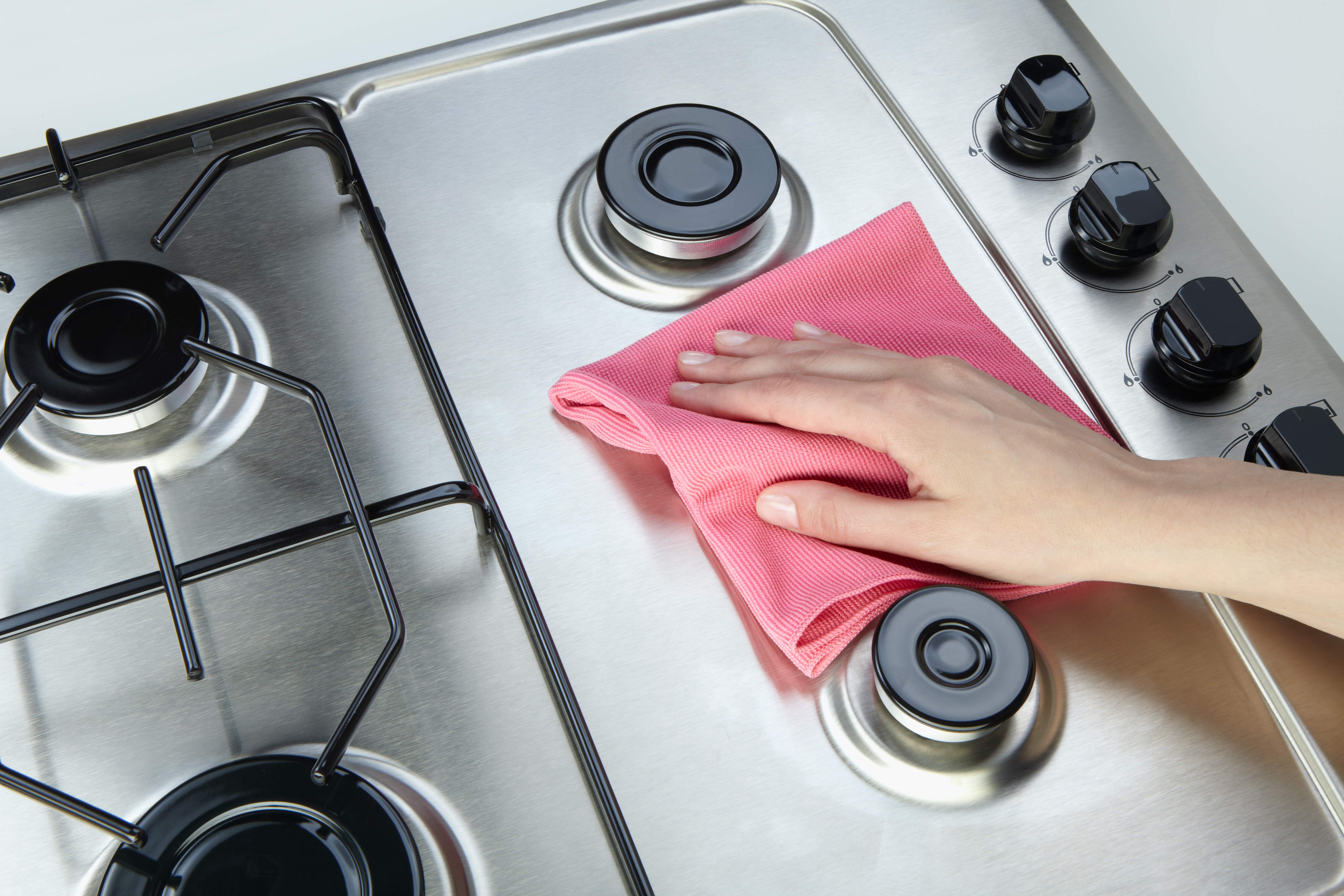 Person cleaning a stove